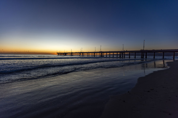 USA, California, Venice, Calm ocean and Venice Pier at sunset