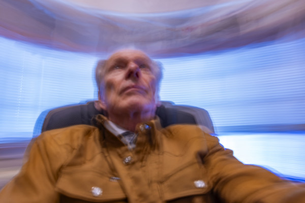 Senior man in desk chair, motion blurred. Bellevue, Idaho, USA.