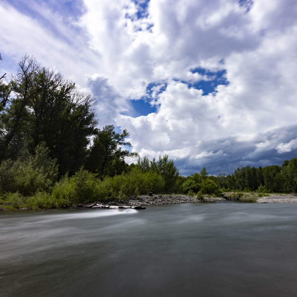 Clouds above motion blurred Big Wood River. Bellevue, Idaho, USA.