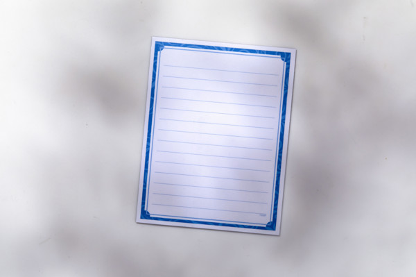 Blank lined notepad on white background. New York City, New York State, USA.