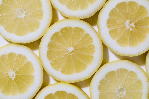 Close-up of sliced lemons on white background. New York City, New York State, USA.