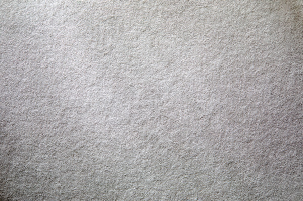 Dappled light on textured white paper. New York City, New York State, USA.