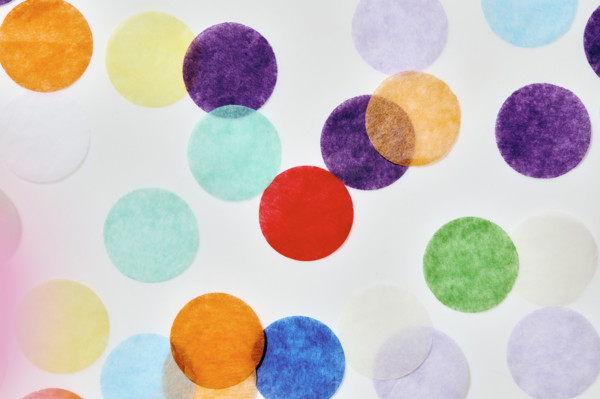 Close-up of colorful confetti on white background. New York City, New York State, USA.