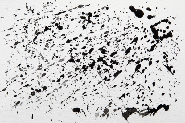 Black paint spatter on white background. New York City, New York State, USA.