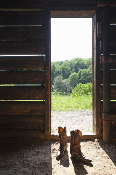 Cowboy boots at barn door. Nashville, Tennessee, USA.