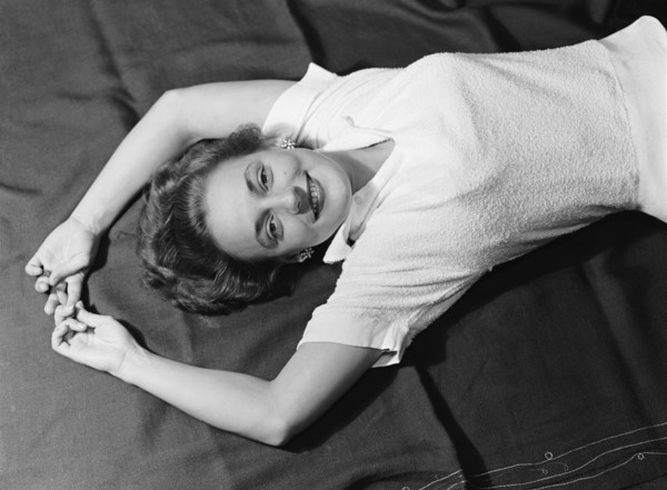 Cecily reclining. Cecily Gaueghan posing for a studio-style portrait. Kenya, 28 April 1953. Kenya,