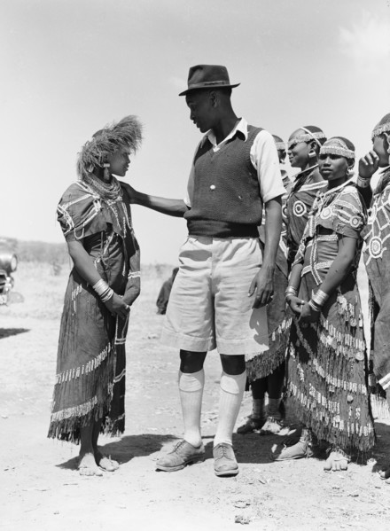 Barabaig chief with young women. A chief from the Barabaig tribe looks down on a young Barabaig