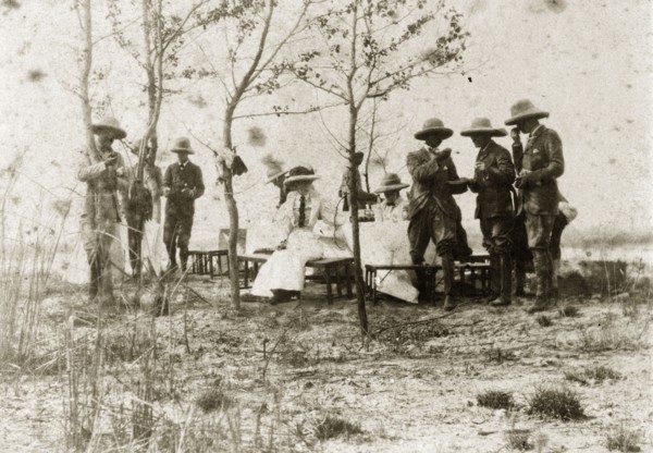 Hunting party lunch. A hunting party comprised of British men and women takes a midday break to eat