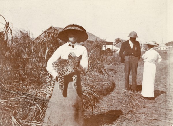 A formidable beast. A European woman wearing a large sun hat holds an Indian Leopard cub (Panthera
