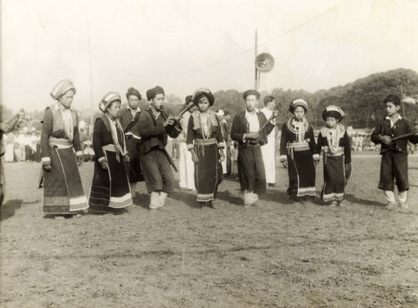 Burmese musicians. A party of Burmese musical performers in traditional dress perform at an outdoor