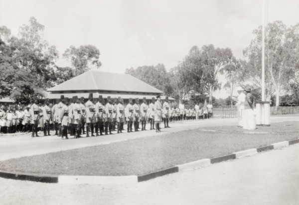Addressing a regiment of the King's African Rifles. Two European men address a regiment of the