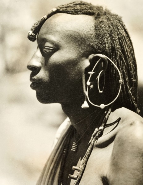 African man with a distinctive earring. Profile shot of the head and shoulders of a young African