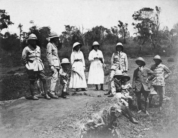 Europeans on an outing. A party of European men, women and children wearing pith hats pose for the