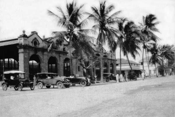 Mackinnon Market at Mombasa. Cars and palm trees line Digo Road in front of Mombasa's municipal