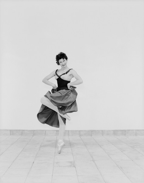 Daphne Dale as Carmen. Dancer Daphne Dale poses for the camera balancing on one toe. Playing the
