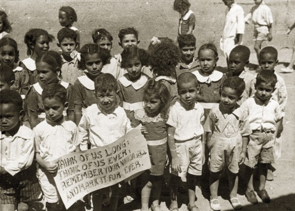 Sudanese schoolchildren. Two boys at the front of a group of African schoolchildren in uniform hold