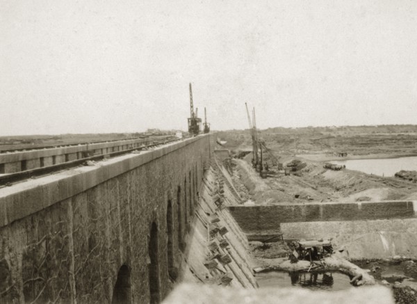 Sennar Dam nearing completion. Cranes and earthworks on the construction site of the nearly