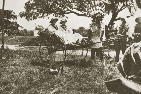 Rickshaw puller in Durban. A rickshaw puller wearing traditional costume and a flamboyantly