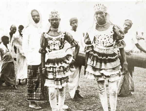 Ceylonian dancers. Two Ceylonian men dressed in traditional dance costumes wear ornate headdresses