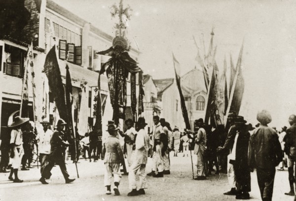 Chinese New Year procession. Banners and flags are paraded through town in celebration of the
