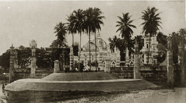 Malaysian mosque. Steps lead up to a decorative, domed mosque surrounded by palm trees. Singapore,