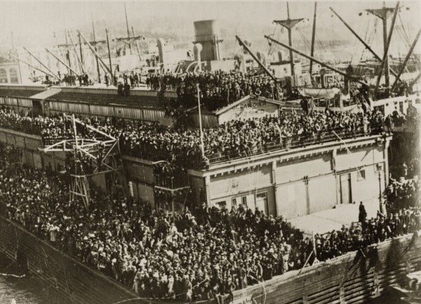 Leaving party. Hoards of people crowd together on every available ledge to wave goodbye to the