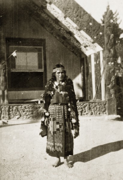 Portrait of a Maori guide. Portrait of a Maori guide outside an elaborately carved building.