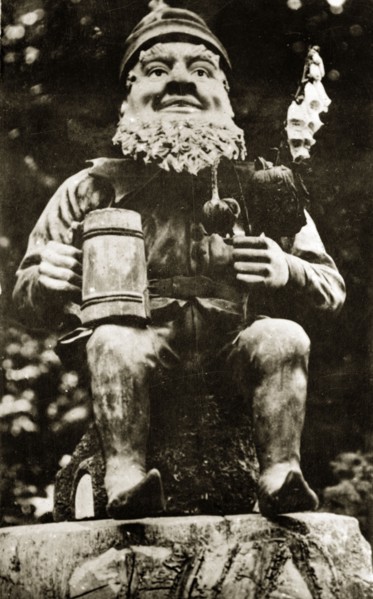 Elf in the sunken gardens. An model elf, flowers and tankard in hand, at Butchart gardens.