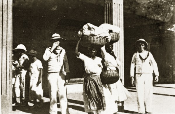 Jamaican street scene. Uniformed sailors from the British Special Service Squadron pose for the