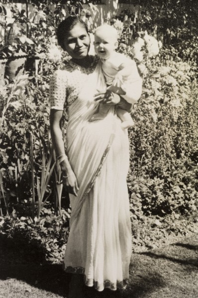 An Indian ayah poses with infant. Dressed in a flowing sari, an Indian ayah (nursemaid) identified