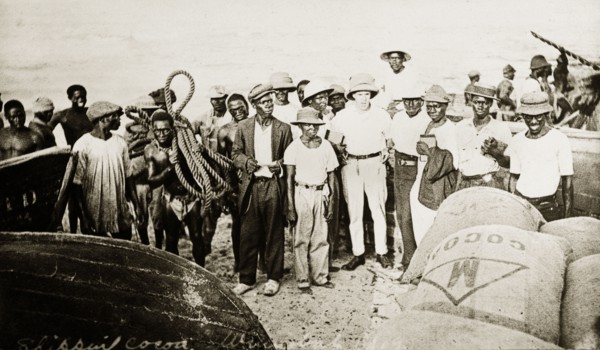 Tamlin and cocoa. Mr Alfred Tamlin (the European man in the centre) stands amongst a crowd of