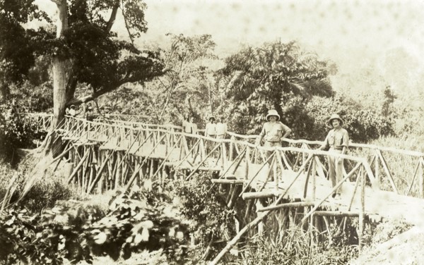 Timber bridge near Accra. Europeans and Africans pose for the camera on a timber bridge near Accra.