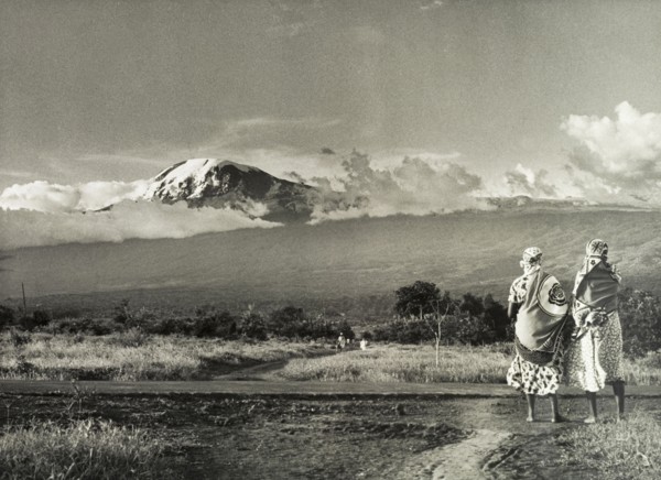 Kilimanjaro skyline. Two African women take in a view of Mount Kilimanjaro. Tanganyika Territory