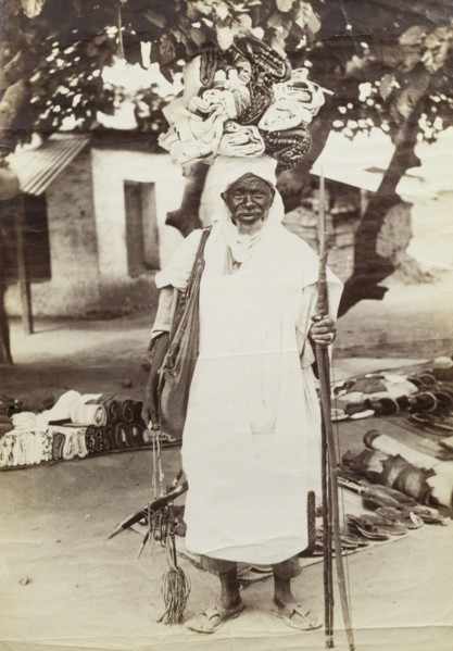 Curio seller at Accra. Outdoors portrait of an aged and apparently well-known itinerant vendor,