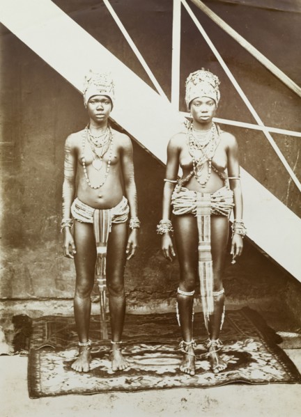 Two women in beaded dress, Gold Coast. Outdoors portrait of two young women wearing elaborate