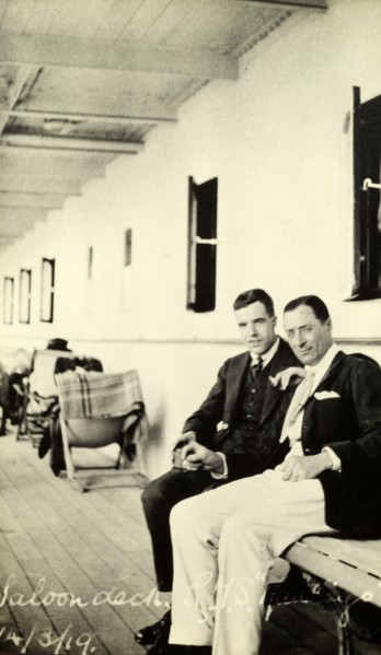 Tamlin on deck. Two gentlemen chat on the saloon deck of a passenger ship. The man on the left is