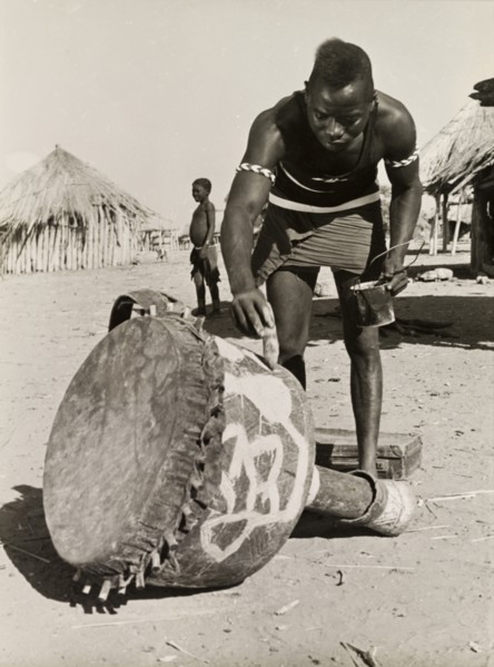 Painting a djembe drum. A Tonga (Batonga) man in traditional dress paints a decorative pattern onto