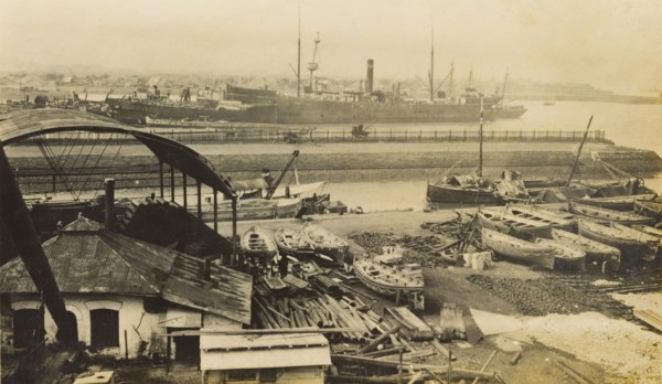 Mazapon Dock, Bombay. View of Mazapon Dock, showing a steamship and fishing trawlers at harbour.