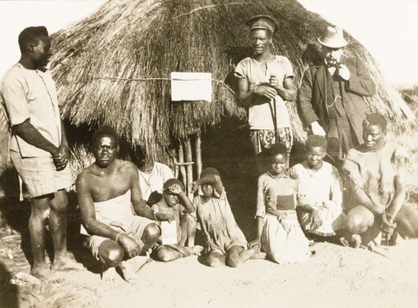 Portrait of workers and children at Balloch Farm. Portrait of a group of male African farm workers,
