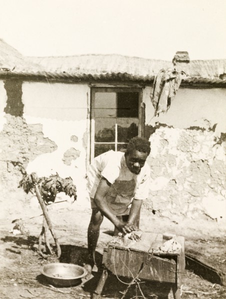 A domestic servant at Balloch Farm. A domestic servant at Balloch Farm scrubs his hands clean,