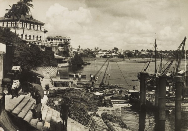 Mombasa Old Port, 1950. View across Mombasa's Old Port showing tradesmen unloading crates from