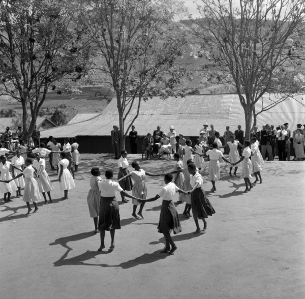 Schoolgirls dance for Princess Margaret. Princess Margaret and her entourage watch a group of