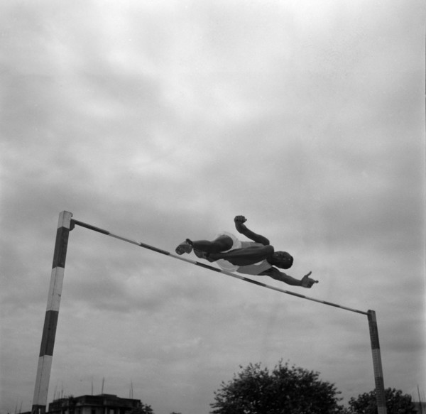 Patrick Etola jumps the bar. Ugandan high jumper Patrick Etola stretches over the high jump pole at