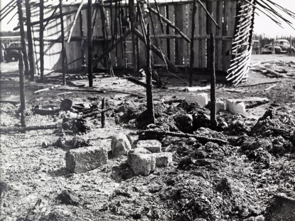 Destruction after a Mau Mau raid. The charred remains of a village destroyed in a raid by Mau Mau