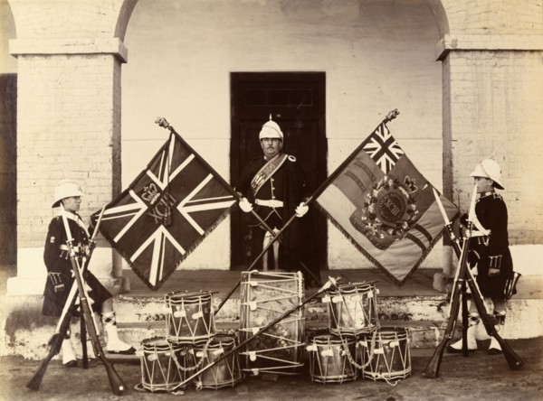Colours of the 93rd Highlanders. Three uniformed soldiers from the 93rd Highlanders pose proudly