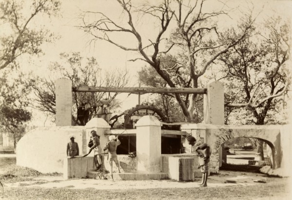 An Indian 'bheesti' visits the well. An Indian 'bheesti' or water carrier hauls a heavy bag of