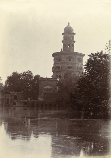 Ornate Hindu temple. An ornate Hindu temple perched on the edge of a lake is silhouetted against