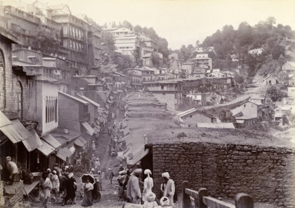 Bustling market street at Murree. Shop awnings line a bustling market street that winds down from