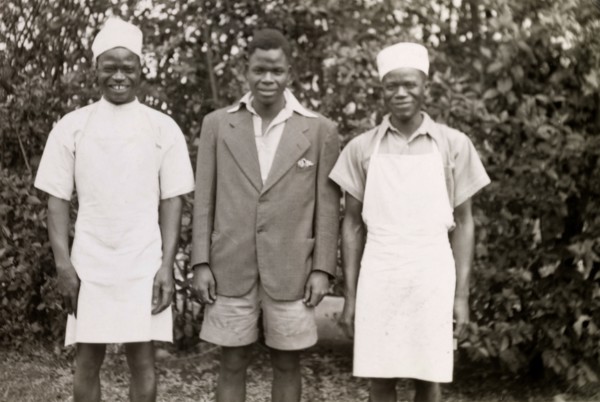 Domestic servants. Three domestic servants in workwear smile for the camera, their roles identified