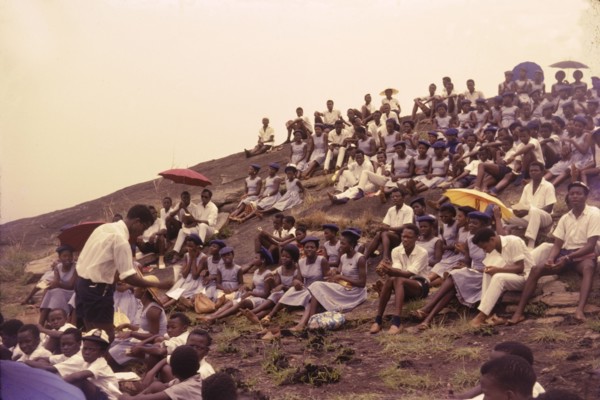 Student union picnic, Nigeria. Uniformed students from a Church of Nigeria college sit on a
